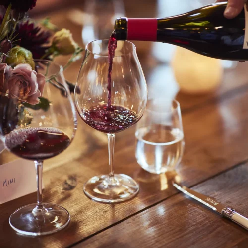 Lingua Franca wine being poured into 2 wine glasses